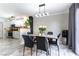 Inviting dining area with modern decor, marble floors, and adjacent kitchen at 509 Chestnut View Pl, Henderson, NV 89052