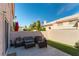 Enclosed patio with seating area and small grass lawn, providing a private outdoor space for relaxation and entertaining at 509 Chestnut View Pl, Henderson, NV 89052