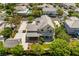 Impressive aerial view of a two-story home with landscaping, a driveway, and a detached garage in a residential neighborhood at 5128 Blissful Valley Cir, Las Vegas, NV 89149