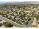 Expansive aerial view of a residential area featuring numerous homes with lush landscaping and community roads at 5128 Blissful Valley Cir, Las Vegas, NV 89149