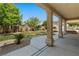 Covered patio overlooks a well-maintained lawn, trees, and landscaping at 5128 Blissful Valley Cir, Las Vegas, NV 89149