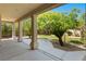 View of the backyard from the covered patio with landscaped yard at 5128 Blissful Valley Cir, Las Vegas, NV 89149