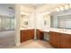Dual sinks with wood cabinets provide storage in this spacious bathroom at 5128 Blissful Valley Cir, Las Vegas, NV 89149
