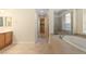 Bright bathroom features a soaking tub, shower, and tile flooring at 5128 Blissful Valley Cir, Las Vegas, NV 89149