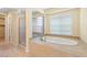 Bright bathroom features a soaking tub, shower, and linen closet at 5128 Blissful Valley Cir, Las Vegas, NV 89149