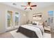 Cozy bedroom with a ceiling fan, access to a balcony, and bright natural light at 5128 Blissful Valley Cir, Las Vegas, NV 89149