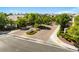 Scenic gated community entrance featuring lush landscaping and well-maintained brick-paved roads at 5128 Blissful Valley Cir, Las Vegas, NV 89149
