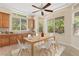 Bright dining area with built in cabinets, a modern table, and large windows offering natural light at 5128 Blissful Valley Cir, Las Vegas, NV 89149