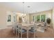 Bright dining room with large windows, elegant lighting and an open concept design at 5128 Blissful Valley Cir, Las Vegas, NV 89149