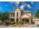 Stunning two-story home with stone accents, a welcoming porch, and a well-manicured front yard at 5128 Blissful Valley Cir, Las Vegas, NV 89149