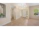 Inviting foyer with tile flooring, decorative lighting, and natural light from the large window at 5128 Blissful Valley Cir, Las Vegas, NV 89149