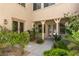 Charming front entrance with decorative columns, lush greenery, and a tranquil garden setting at 5128 Blissful Valley Cir, Las Vegas, NV 89149