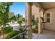 Inviting front porch with wooden columns, lush greenery, and a view of the landscaped front yard at 5128 Blissful Valley Cir, Las Vegas, NV 89149