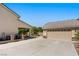 Spacious three-car garage with a large driveway and mature landscaping at 5128 Blissful Valley Cir, Las Vegas, NV 89149
