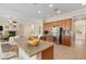 Spacious kitchen features an island with granite countertops, stainless steel appliances, and ample cabinet space at 5128 Blissful Valley Cir, Las Vegas, NV 89149