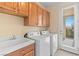 Functional laundry room with washer, dryer, utility sink, and ample cabinet space at 5128 Blissful Valley Cir, Las Vegas, NV 89149