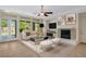 Cozy living room with a fireplace, neutral decor, bright light and access to the backyard at 5128 Blissful Valley Cir, Las Vegas, NV 89149