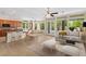 Open-concept living space with a kitchen island, dining area, comfortable seating and backyard access at 5128 Blissful Valley Cir, Las Vegas, NV 89149