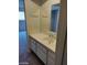 Bathroom with cabinet and sink. A mirror hangs above the sink, and you can see the bedroom in the background at 5175 Palmyra Ave, Las Vegas, NV 89146