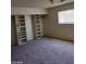 Bright bedroom with neutral carpet and large built-in shelves and closet at 5175 Palmyra Ave, Las Vegas, NV 89146