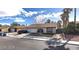 Charming single-story home with desert landscaping, two-car garage and mature palm trees at 5175 Palmyra Ave, Las Vegas, NV 89146
