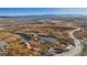 An aerial view highlights a natural landscape with ponds, trails, and dry vegetation, perfect for outdoor enthusiasts at 5184 Mineral Lake Dr, Las Vegas, NV 89122