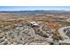 Wide aerial perspective of a building and parking lot in a natural setting, with a network of trails and waterways at 5184 Mineral Lake Dr, Las Vegas, NV 89122