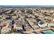 A high-angle shot displays a neighborhood with houses, trees, and parked cars, set against a backdrop of distant mountains at 5184 Mineral Lake Dr, Las Vegas, NV 89122