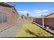 This cozy backyard has green grass and patio space plus a block wall that provides ample privacy at 5184 Mineral Lake Dr, Las Vegas, NV 89122