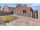 A well maintained backyard with grass, pavers, and block wall fence at 5184 Mineral Lake Dr, Las Vegas, NV 89122