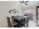 Charming dining area with a modern table, seating for six, and a sliding glass door to the exterior at 5184 Mineral Lake Dr, Las Vegas, NV 89122