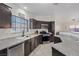 Modern kitchen featuring granite countertops, dark cabinetry and stainless steel appliances at 5184 Mineral Lake Dr, Las Vegas, NV 89122