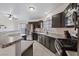 Well-appointed kitchen with dark cabinetry, granite countertops, and stainless steel appliances at 5184 Mineral Lake Dr, Las Vegas, NV 89122