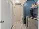 Functional laundry room featuring modern washer and dryer, storage shelves, and convenient access to other areas at 5184 Mineral Lake Dr, Las Vegas, NV 89122