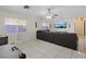 Bright living room with ample space, featuring a large sectional sofa and a ceiling fan for comfort at 5184 Mineral Lake Dr, Las Vegas, NV 89122