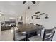 Open-concept living space with dining area, sectional sofa, and ample natural light from the windows at 5184 Mineral Lake Dr, Las Vegas, NV 89122