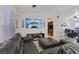 Bright living room features a sectional sofa, entertainment center with fireplace, and modern décor at 5184 Mineral Lake Dr, Las Vegas, NV 89122