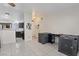 Open concept living space with tile flooring seamlessly blends into the adjacent kitchen at 5184 Mineral Lake Dr, Las Vegas, NV 89122