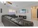 Spacious living room featuring a large leather sectional sofa, TV, and decorative fireplace at 5184 Mineral Lake Dr, Las Vegas, NV 89122