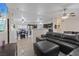 Open living space with sectional sofa, dining area, and a view of the modern kitchen, ideal for entertaining at 5184 Mineral Lake Dr, Las Vegas, NV 89122