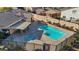 Aerial view of a community pool with a hot tub, covered seating, and landscaped areas providing an inviting outdoor space at 5184 Mineral Lake Dr, Las Vegas, NV 89122