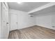 Basement with vinyl plank flooring, white walls and ceiling, and updated lighting at 54 Del Amo Dr, Las Vegas, NV 89110