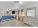 Bedroom featuring tile floors, a queen bed, large dresser, and a large window at 54 Del Amo Dr, Las Vegas, NV 89110