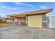 Charming single-story home with a yellow garage door and desert landscaping in front at 54 Del Amo Dr, Las Vegas, NV 89110