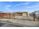Single-story house with a wrought iron fence, rock landscaping, and solar panels on the roof at 54 Del Amo Dr, Las Vegas, NV 89110
