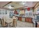 Well-equipped kitchen featuring wooden cabinets, stainless steel appliances, and a cozy dining area at 54 Del Amo Dr, Las Vegas, NV 89110