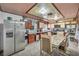 Spacious kitchen featuring stainless steel appliances, granite countertops, and tile flooring at 54 Del Amo Dr, Las Vegas, NV 89110