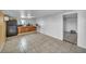 Spacious kitchen with dark cabinets, tiled floor, and backyard access at 54 Del Amo Dr, Las Vegas, NV 89110