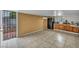 Spacious kitchen with dark cabinets, tiled floor, and backyard access at 54 Del Amo Dr, Las Vegas, NV 89110