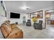 Cozy living room with tile floors, neutral walls, and a view into the kitchen at 54 Del Amo Dr, Las Vegas, NV 89110